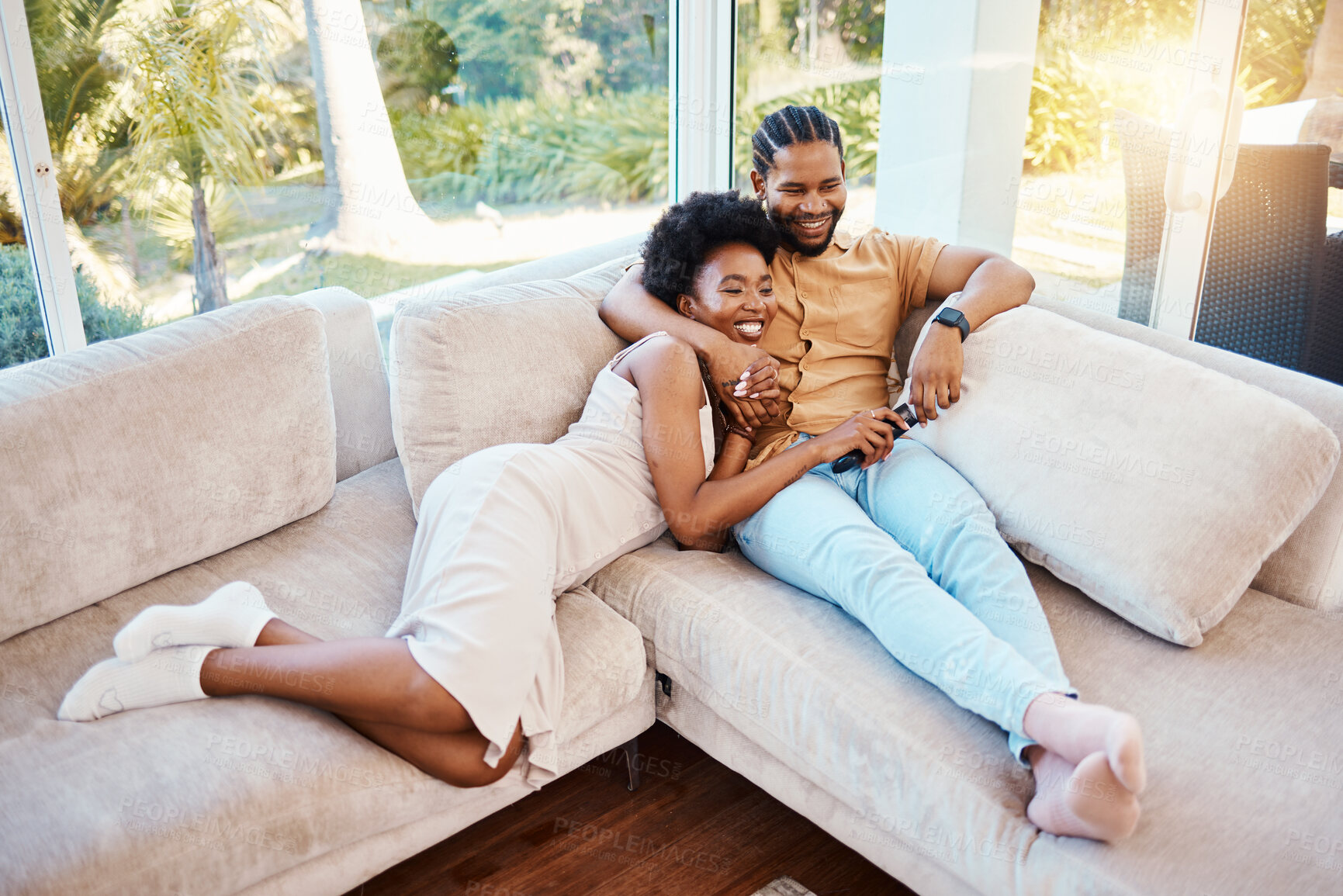 Buy stock photo Happy, above and a black couple on the sofa, watching tv and talking in a house. Smile, love and an African man and woman with care, speaking and conversation on the living room couch for a movie