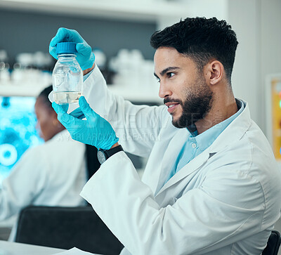 Buy stock photo Science, research and man with solution in bottle in laboratory, results and medical engineering with water sample. Biotechnology, botany study and nature, scientist or lab technician checking glass.