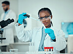 Science, blood and research, black woman with test tube in laboratory and medical engineering solution. Biotechnology, vaccine study and liquid in pipette, scientist or lab technician checking sample