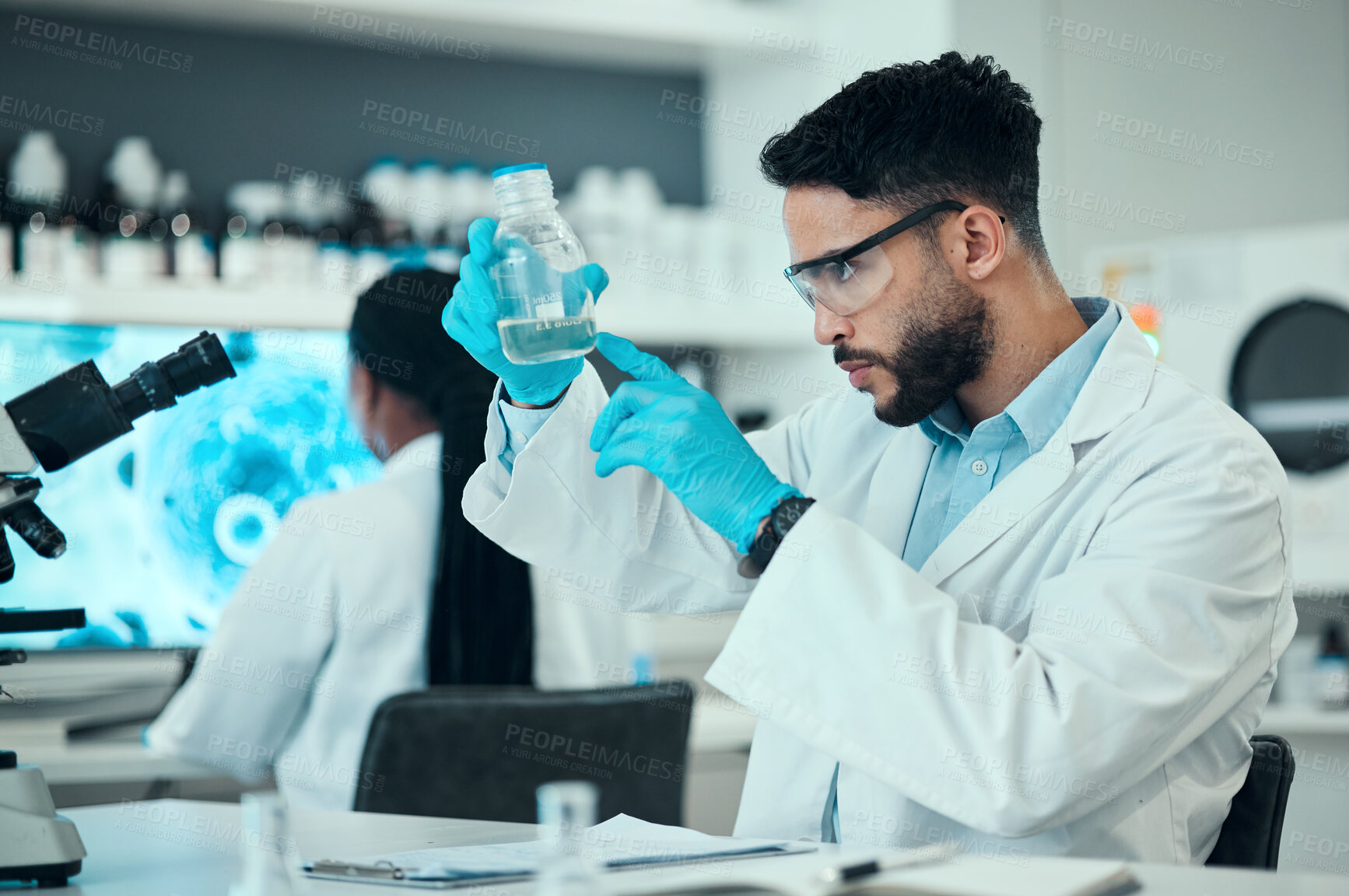 Buy stock photo Science, safety and research, man with glass in lab and medical engineering with pharmaceutical solution. Biotechnology, vaccine study and liquid, scientist or laboratory technician checking bottle.