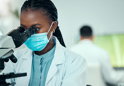 Buy stock photo Microscope, science and female scientist with a face mask in a medical pharmaceutical lab. Professional, scientific and African woman researcher working on virus research with biotechnology equipment