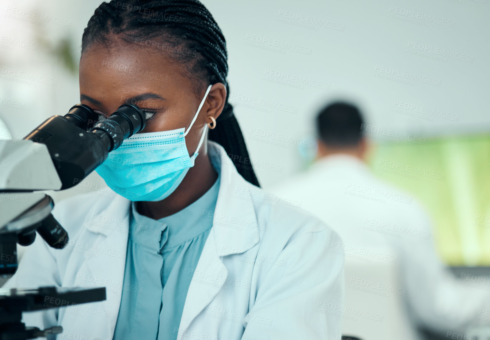 Buy stock photo Microscope, science and female scientist with a face mask in a medical pharmaceutical lab. Professional, scientific and African woman researcher working on virus research with biotechnology equipment