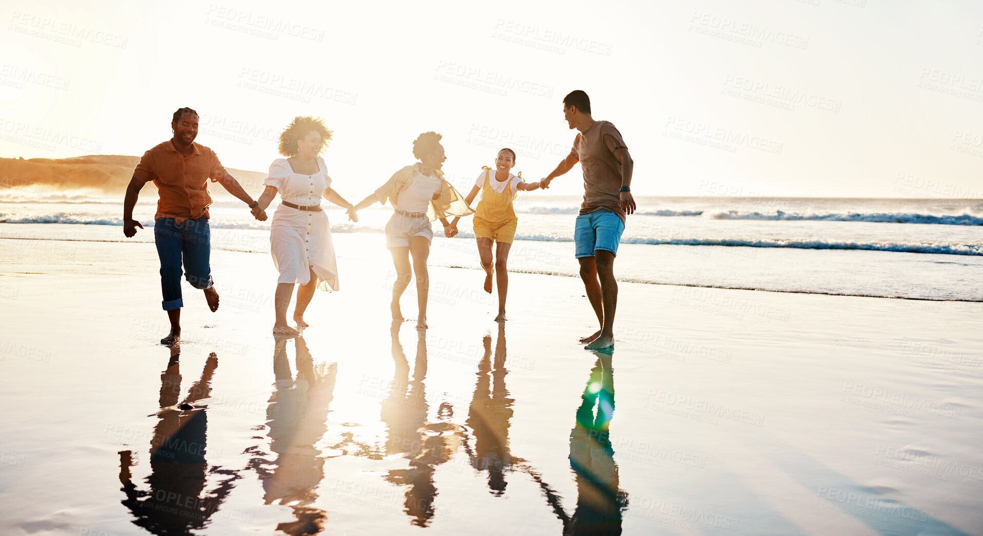 Buy stock photo Friends, running and people happy at sunset beach for fun, freedom and travel with care. Diversity, men and women group holding hands in nature with sand, love and happiness on a vacation or holiday