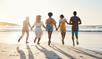 Buy stock photo Friends, holding hands and running at sunset on beach in summer, vacation or walking together on holiday break with freedom. Group, silhouette and people with connection and support in community