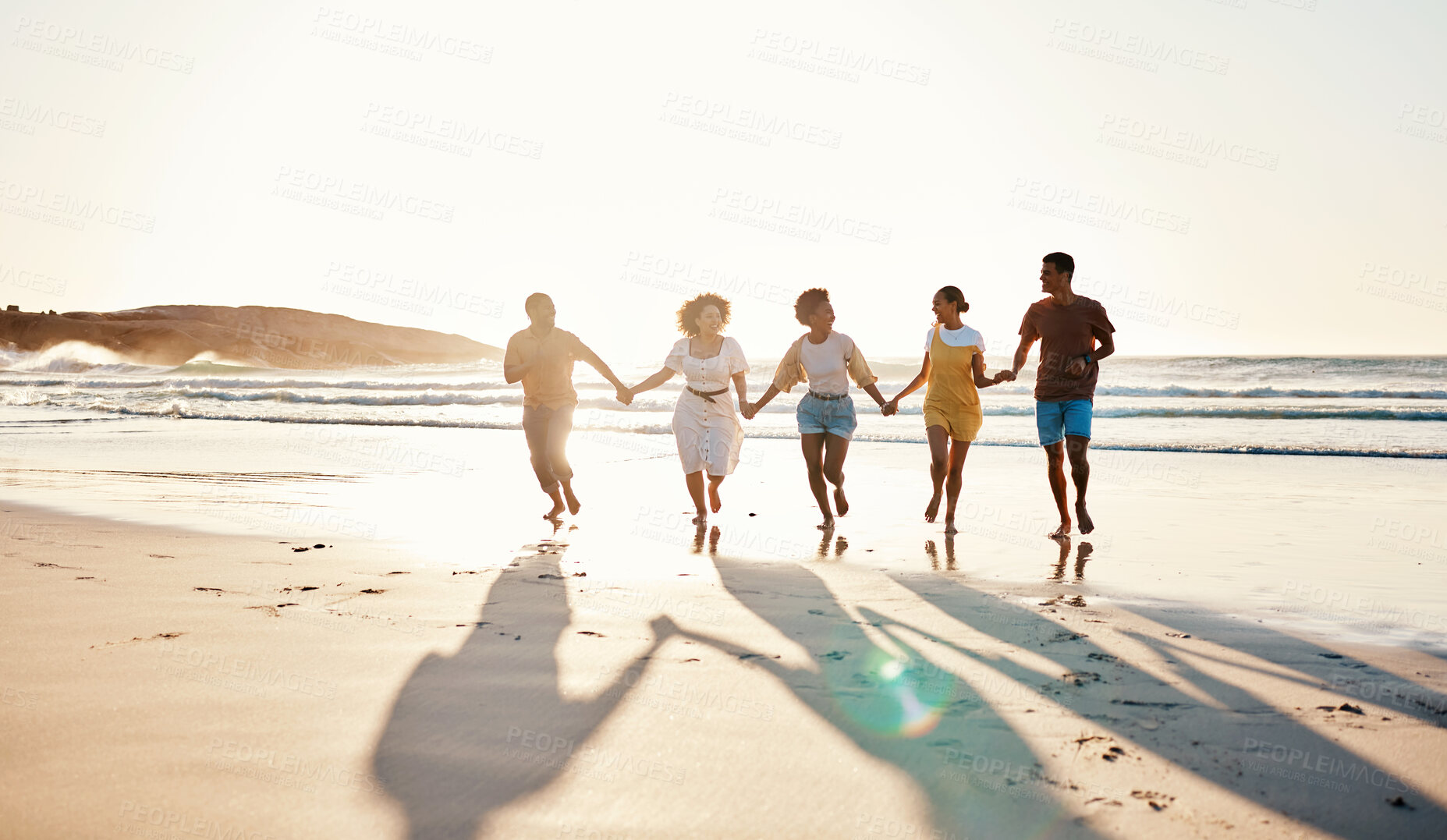 Buy stock photo Friends, holding hands and running at sunset on beach in summer or walking together on holiday in California with freedom. Group, silhouette or vacation with connection or support in community