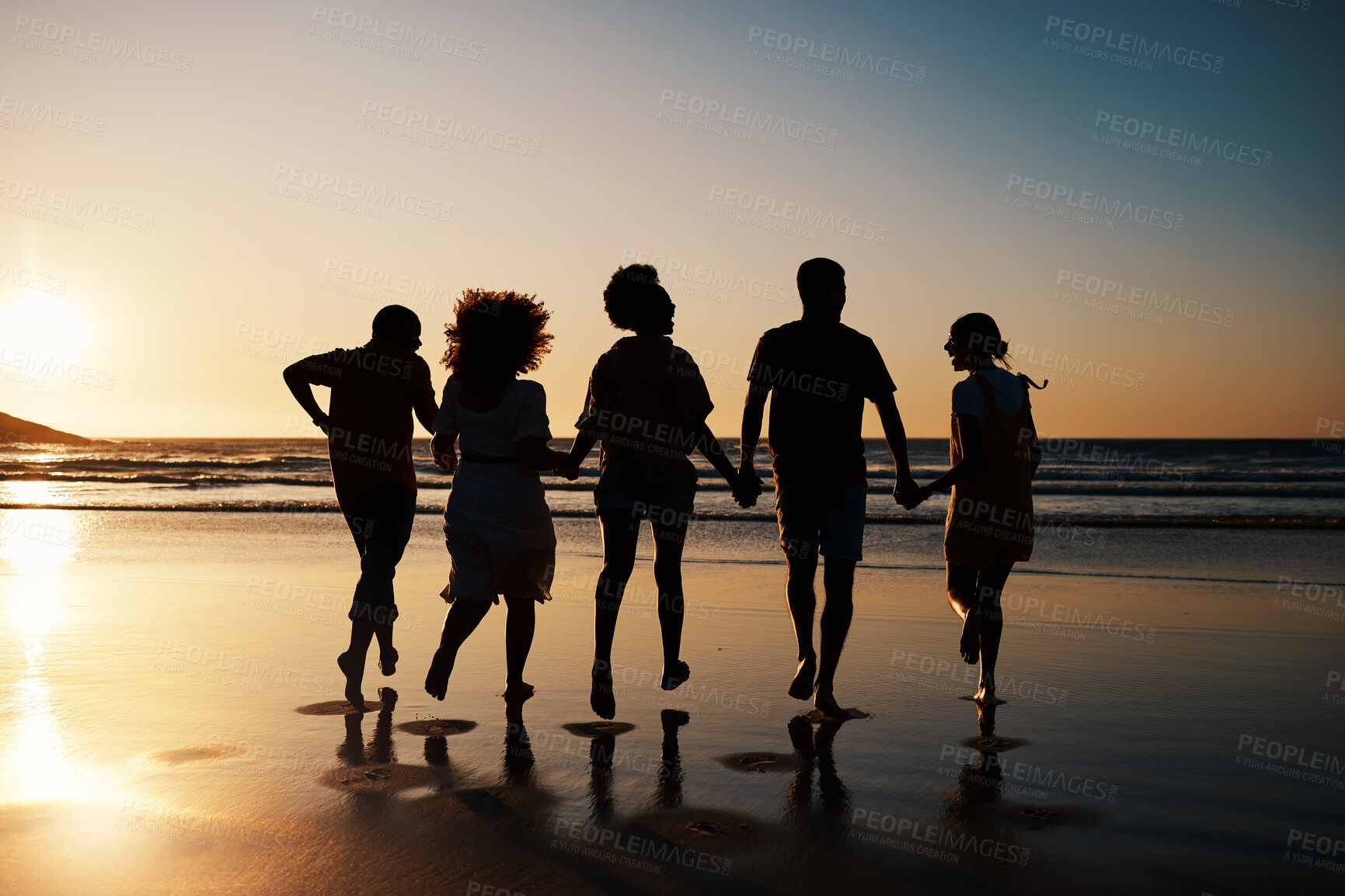 Buy stock photo Beach, sunset and back of friends holding hands with freedom, bond and fun on summer vacation. Ocean, silhouette and rear view of people together at the sea for travel, holiday or adventure in Miami