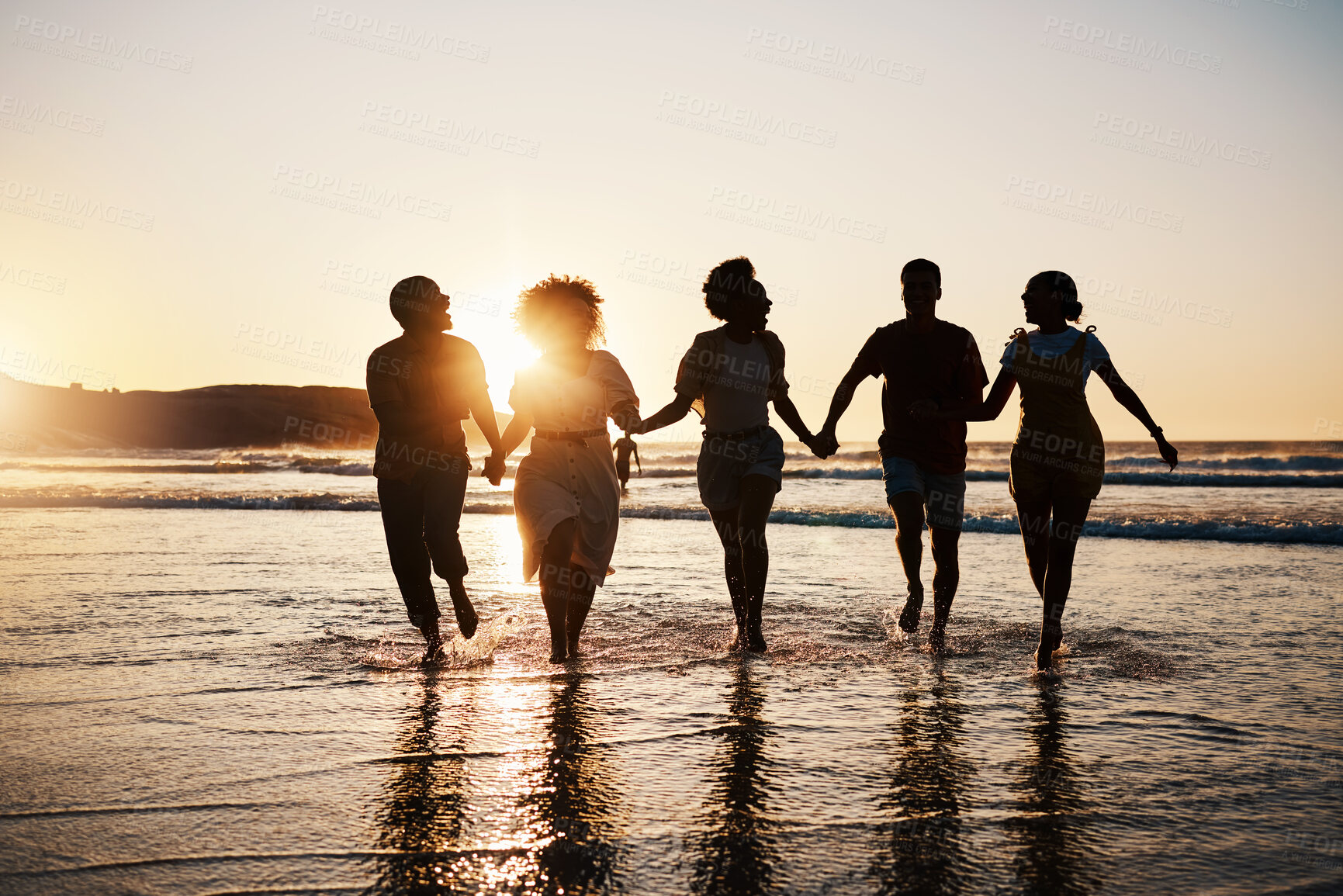 Buy stock photo Holding hands, silhouette and friends at the beach with freedom, fun and bonding at sunset. Ocean, shadow and group of people at the sea for travel, adventure and journey in sea trip in Los Angeles