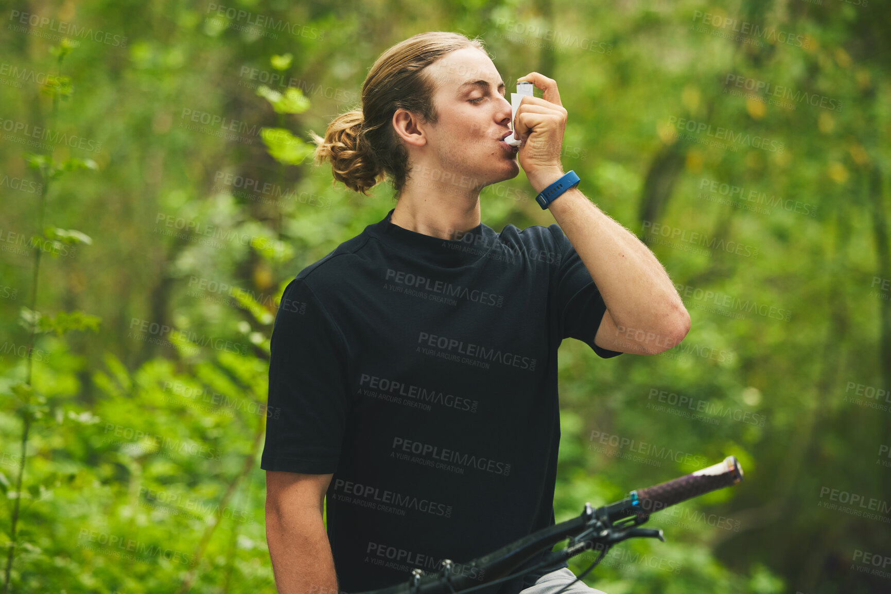 Buy stock photo Asthma, fitness and man cyclist on a bicycle in a forest with breathing medical emergency during exercise or training. Outdoor, lung support and athlete with inhaler in nature for workout or wellness