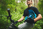 Mountain bike, man and helmet, nature and sports with adventure and fitness in forest. Cycling outdoor, biker and travel with athlete, exercise training and ready to ride, bicycle and challenge