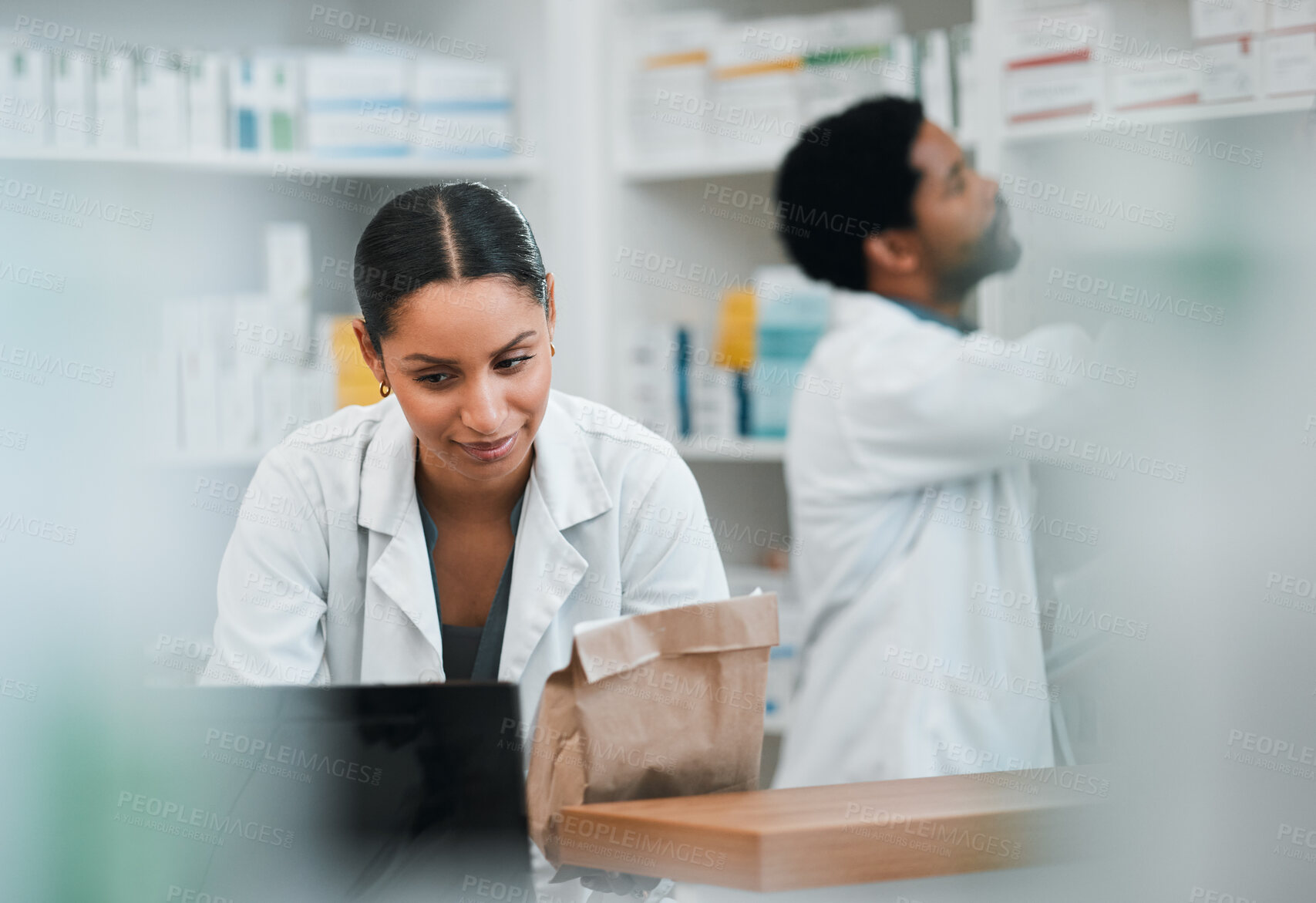 Buy stock photo Woman, pharmacist and team in inventory inspection or checking stock or medication at the pharmacy. People, medical or healthcare professional looking at pharmaceuticals together at the drugstore