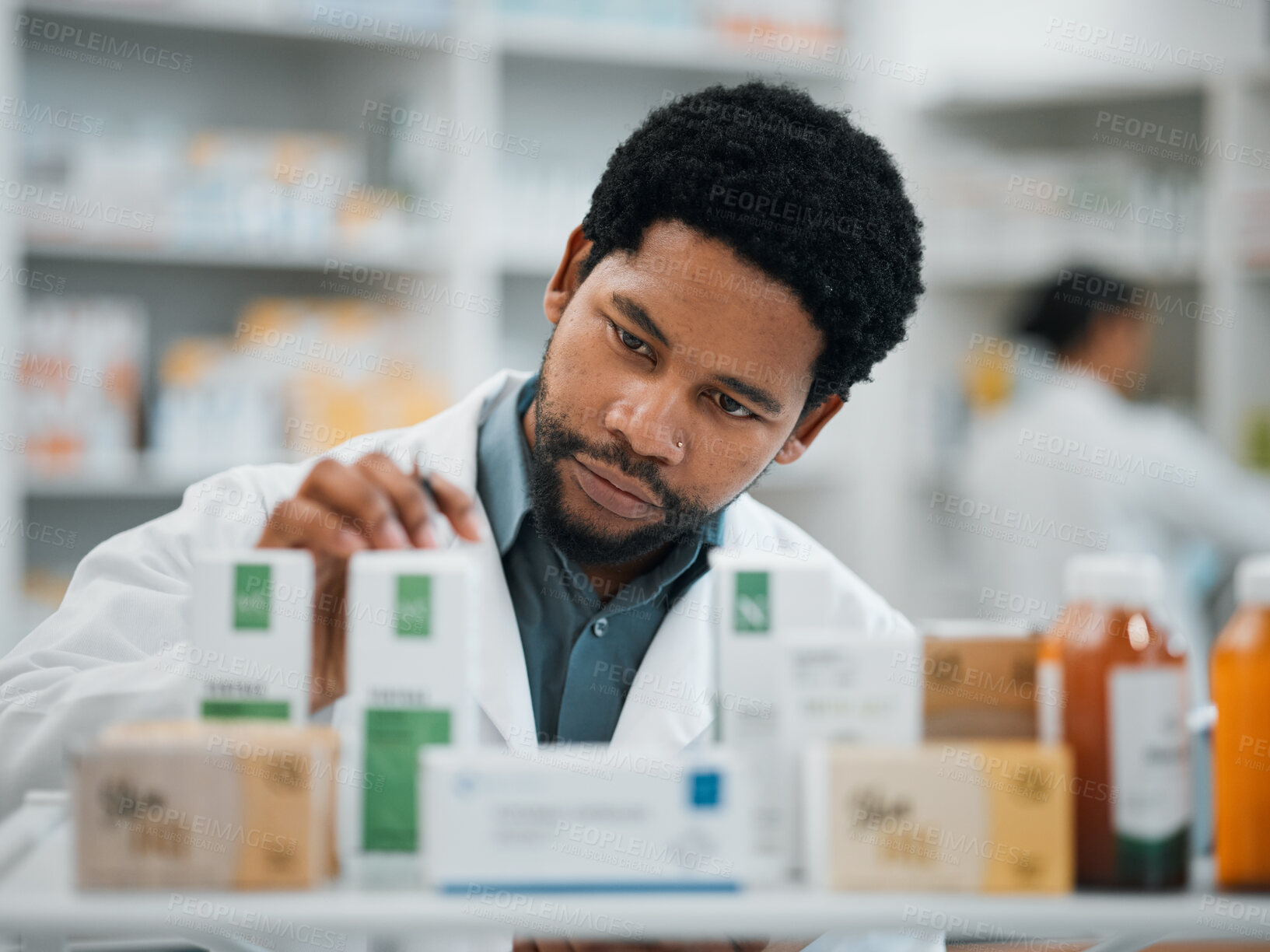 Buy stock photo Black man, pharmacist and check stock, pills and health, prescription medicine and supplements in pharmacy. Organize inventory, healthcare and medical, hospital dispensary and pharmaceutical drugs