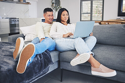 Buy stock photo Laptop, online shopping and couple relaxing on a sofa in the living room of their modern house. Happy, technology and young man and woman networking or browsing on the internet with computer at home.