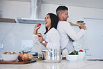 Happy couple, food and cooking meal in kitchen together for healthy eating or natural nutrition at home. Man and woman enjoying teamwork or bonding in happiness for breakfast, lunch or supper