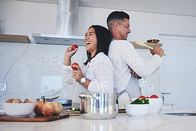 Buy stock photo Happy couple, food and fun cooking in kitchen together for healthy eating or natural nutrition at home. Man and woman enjoying teamwork or bonding in happiness for breakfast, lunch or supper meal