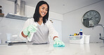 Happy woman, housekeeper and cleaning kitchen table with spray bottle, detergent or bacteria and germ removal at home. Female person maid or cleaner wiping surface with cloth in hygiene or sanitize