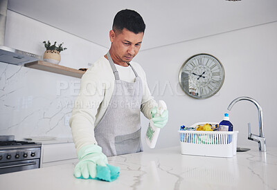 Buy stock photo Man, housekeeper and cleaning table in kitchen, hygiene or germ and bacteria removal at home. Male person, maid or cleaner wiping counter, spray bottle or cloth in sanitize, health and disinfection