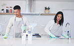 Happy couple, housekeeper and cleaning table in kitchen, chemical equipment or detergent in bacteria and germ removal at home. Man and woman wiping surface with cloth together in hygiene or sanitize