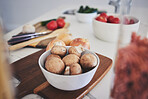 Cooking, food and vegetables on kitchen counter for meal prep, cutting and nutrition on wooden board. Healthy diet, ingredients and closeup of mushrooms in bowl for vegan dinner, lunch and supper