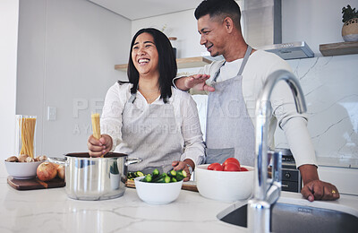 Buy stock photo Laughing, cooking and love with couple in kitchen for food, health and lunch recipe. Happy, nutrition and dinner with man and woman and pasta at home for diet, wellness and romance together