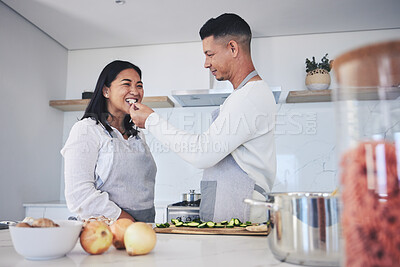 Buy stock photo Feeding, cooking and love with couple in kitchen for food, health and lunch recipe. Happy, nutrition and dinner with man and woman cutting vegetables at home for diet, wellness and romance together