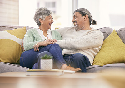 Buy stock photo Happy, mature couple and relax on sofa in home for love, care and bonding together with marriage partner. Man, woman and hug on couch with smile, support and loyalty for relationship in living room