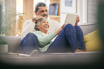 Buy stock photo Mature couple, relax and happy on sofa with tablet for streaming a funny, comedy show or movie together in lounge. Reading, man and woman in retirement with social media or app for communication