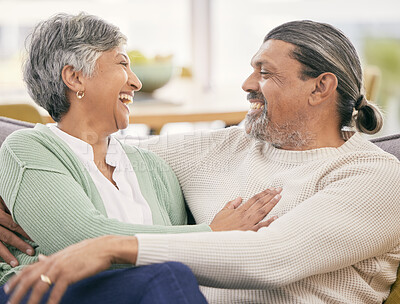 Buy stock photo Mature couple, hug and smile on sofa in home for love, care and laugh together with marriage partner. Happy man, woman and embrace on couch in living room for trust, relax and support of relationship