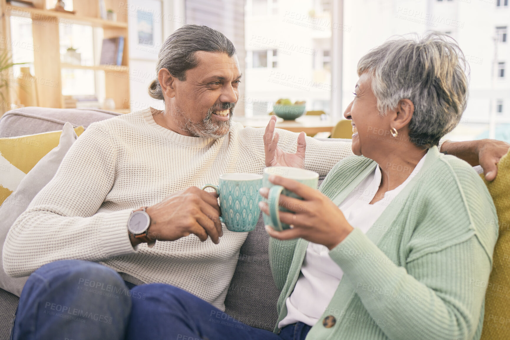 Buy stock photo Coffee, conversation and mature couple on sofa for bonding, healthy relationship and connection. Marriage, love and happy man and woman drinking tea on couch to relax in discussion, talking and chat