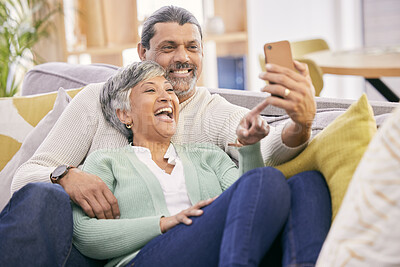 Buy stock photo Mature couple, laugh and phone in home of social media post, meme or mobile app subscription. Happy man, woman and reading funny joke on internet, scroll on smartphone or relax on sofa in living room