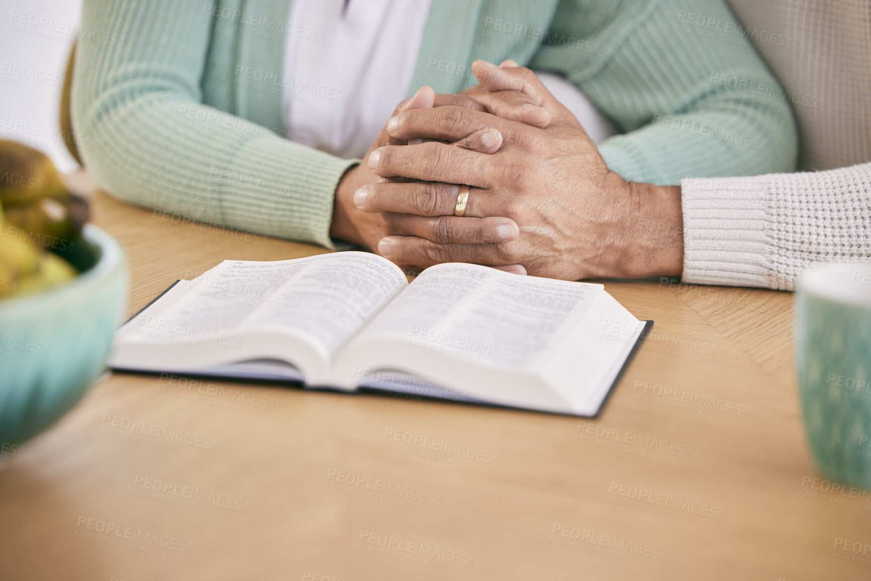 Buy stock photo Reading, bible and senior couple holding hands at home with book study and religion together. Prayer, support and elderly people with worship, learning and christian education with love and care