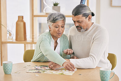 Buy stock photo Puzzle, entertainment and happy senior couple in home for bonding, fun activity and relax together. Retirement, love and man and woman with jigsaw game for playing, hobby and connect in living room