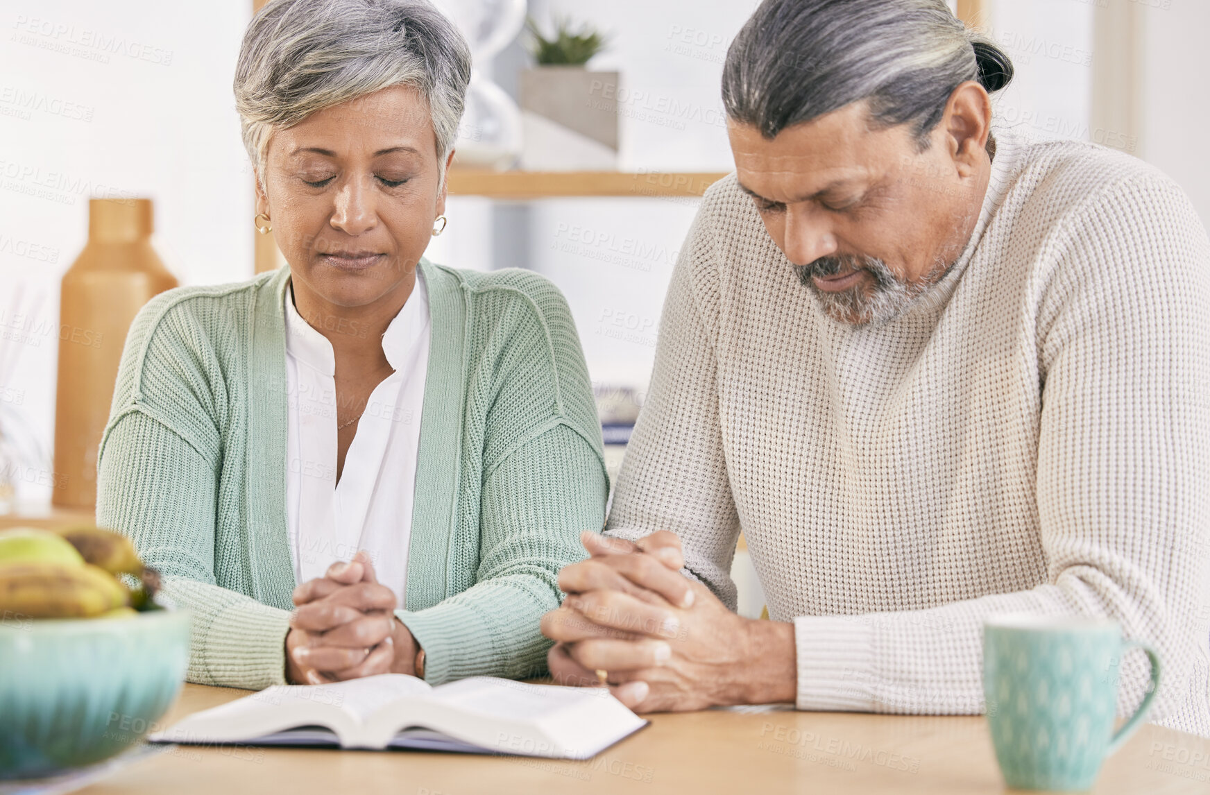 Buy stock photo Praying, book and senior couple at home with bible study and religion together in marriage. Prayer, faith and elderly people with worship, learning and christian solidarity with love and care