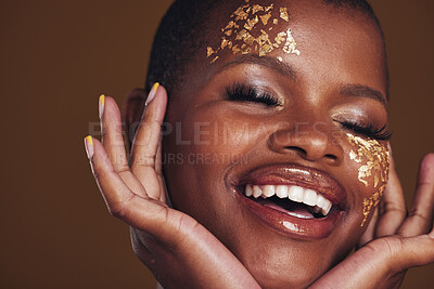 Buy stock photo Gold, laughing and woman face closeup with makeup and luxury treatment with rich spa mask. Glitter, golden dermatology and African person happy from creative skincare and art cosmetics in studio