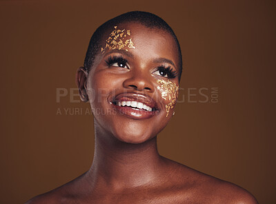 Buy stock photo Gold flakes, makeup and woman beauty with a smile from luxury treatment and facial spa. Glitter art, creative dermatology and African female person from skincare and golden cosmetics in studio