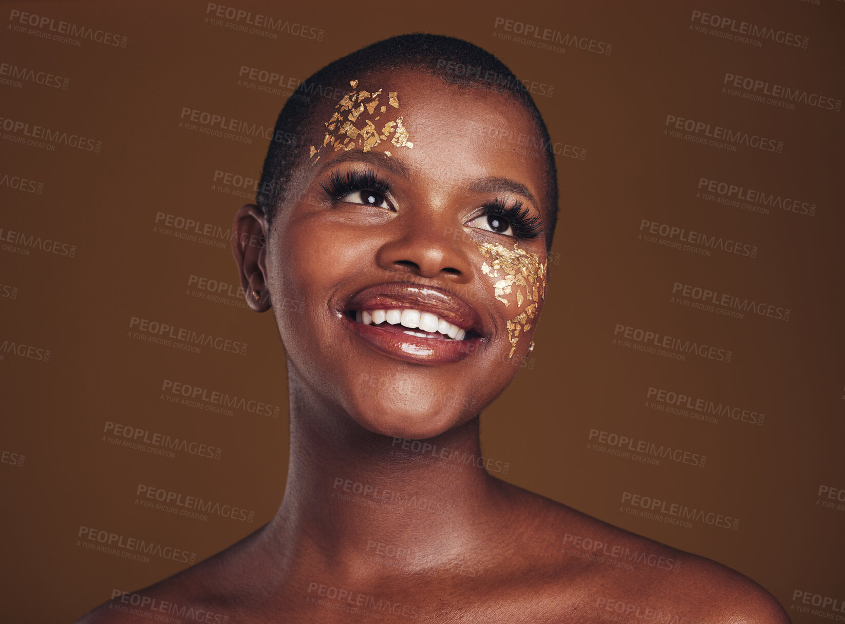 Buy stock photo Gold flakes, makeup and woman beauty with a smile from luxury treatment and facial spa. Glitter art, creative dermatology and African female person from skincare and golden cosmetics in studio