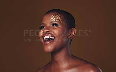 Buy stock photo Gold, makeup and woman laughing with  beauty and luxury treatment and creative spa mask. Glitter, art dermatology and African female person happy from skincare and golden cosmetics in studio