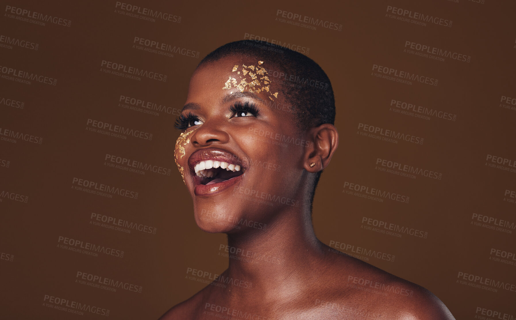 Buy stock photo Gold, makeup and woman laughing with  beauty and luxury treatment and creative spa mask. Glitter, art dermatology and African female person happy from skincare and golden cosmetics in studio