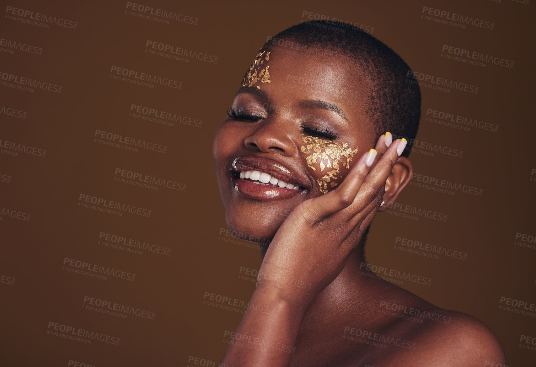 Buy stock photo Gold, makeup and woman with a smile from luxury treatment and facial spa mask. Glitter art, creative dermatology and African female person from skincare and cosmetics in studio with brown background