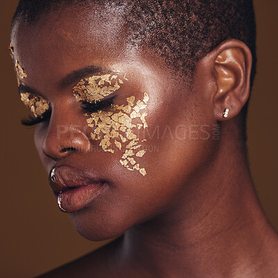 Buy stock photo Gold, art and face of black woman with makeup for beauty aesthetics isolated in a studio brown background eyes closed. Creative, luxury and African person with cosmetic glamour or design for skincare