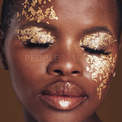 Buy stock photo Gold, art and black woman with makeup for beauty aesthetics isolated in a studio brown background eyes closed. Creative, luxury and face of African person with cosmetic glamour or design for skincare