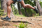 Running, fitness and legs of man in forest for marathon training, exercise and cardio workout. Sports, nature and feet of athlete in woods for wellness, healthy body and endurance for race challenge