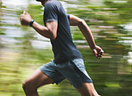 Man, motion blur and running in park for exercise, fitness action and power of cardio workout. Closeup, runner and sports athlete training for marathon with energy, speed and fast performance outdoor