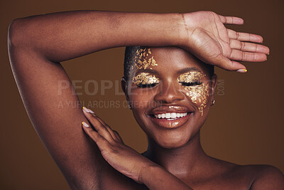 Buy stock photo Gold, creative and art on black woman with makeup for beauty aesthetics isolated in studio brown background eyes closed. Smile, luxury and face of person with cosmetic glamour or design for skincare