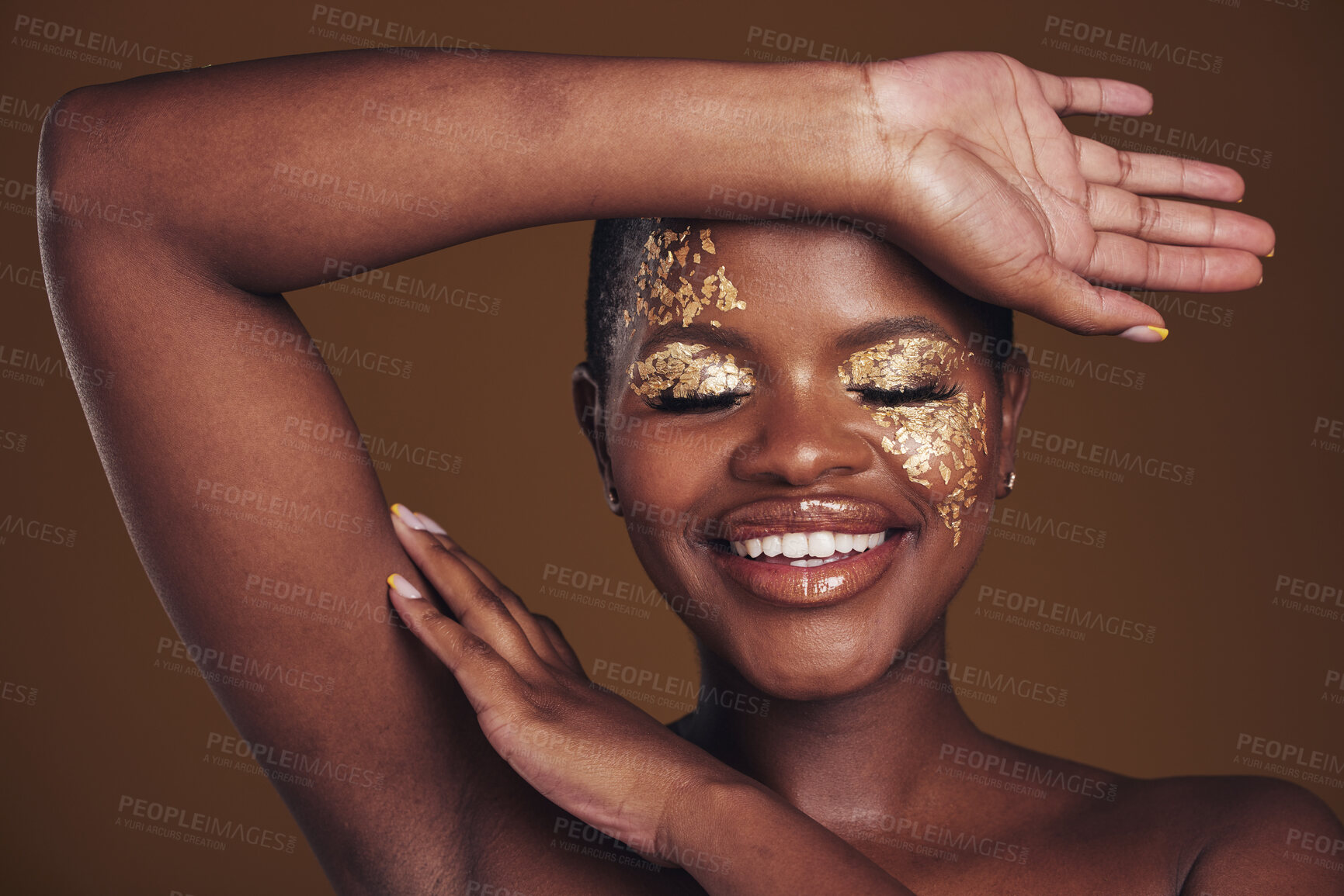 Buy stock photo Gold, creative and art on black woman with makeup for beauty aesthetics isolated in studio brown background eyes closed. Smile, luxury and face of person with cosmetic glamour or design for skincare