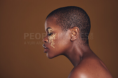 Buy stock photo Art, profile of black woman with gold makeup and blurred background, glitter paint and cosmetics. Shine, glow and African model in studio for beauty, fashion and aesthetic freedom in luxury skincare.