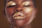 Gold beauty, face and woman closeup with blur in studio with glitter cosmetics and sparkle art. Brown background, African female model and shine from makeup and skin glow with golden luxury treatment