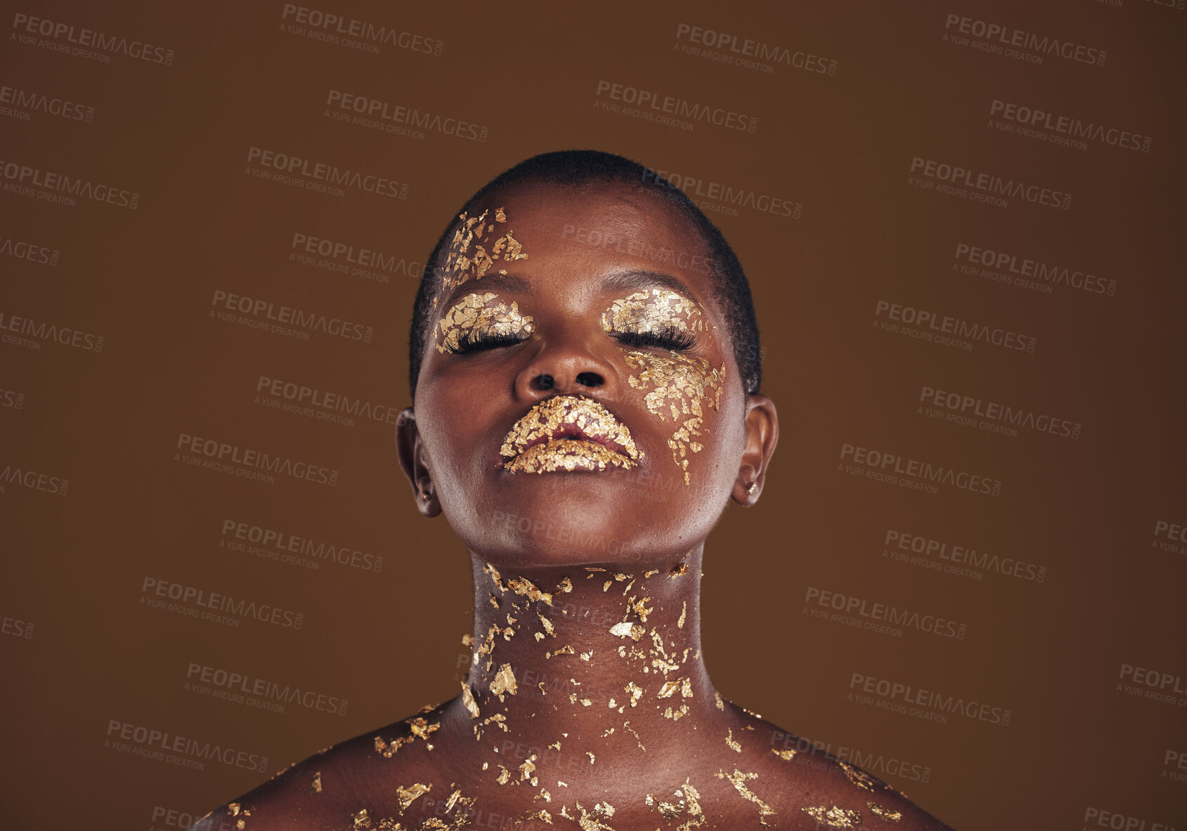 Buy stock photo Beauty, glitter and black woman with gold makeup on brown background with art, paint and cosmetics. Shine, glow and African model in studio for facial fashion, aesthetic freedom and luxury skincare.