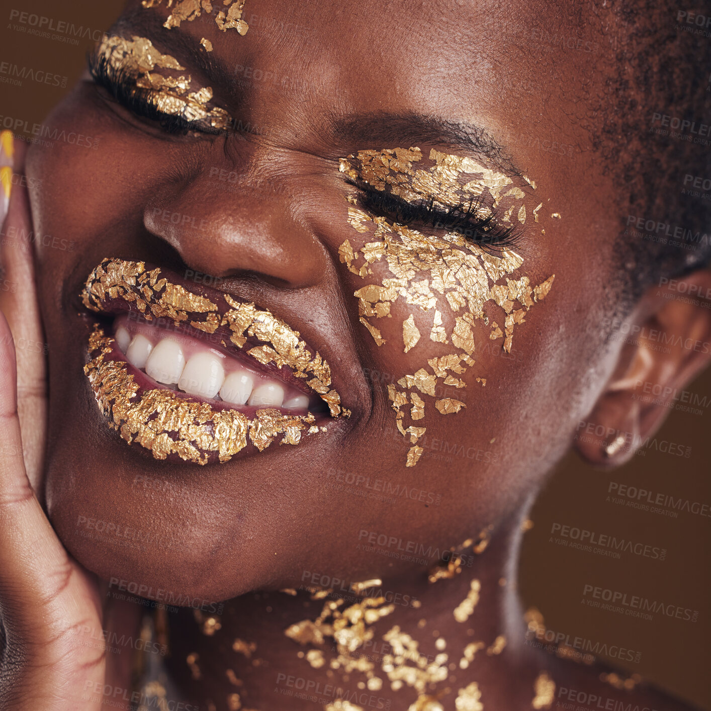 Buy stock photo Black woman, face and gold makeup closeup with luxury dermatology and skincare mask with glitter. Sparkle, smile and beauty with rich and shine of cosmetics and model in a studio with facial art