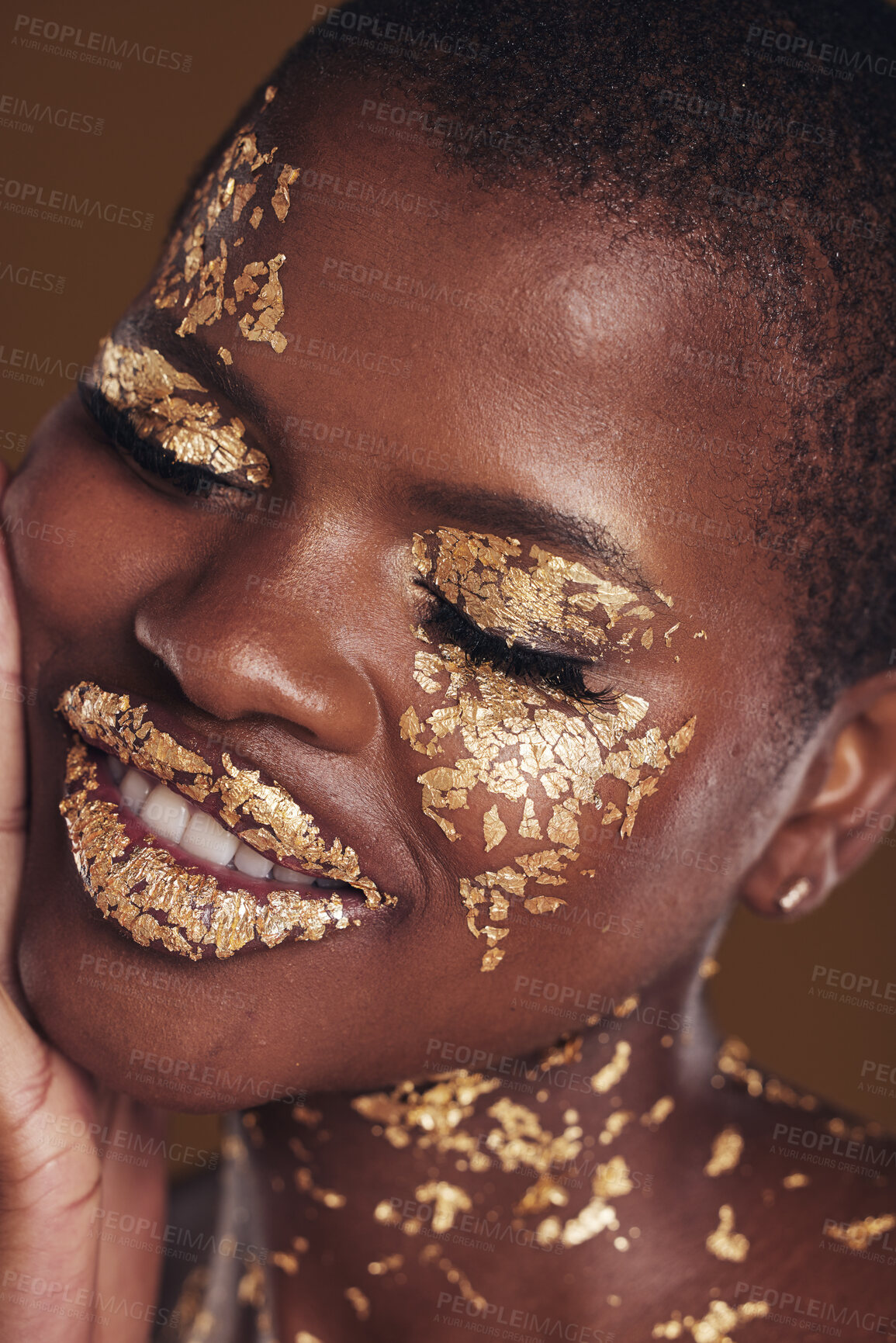 Buy stock photo Black woman, face and gold cosmetics closeup with luxury dermatology and skincare mask with glitter. Sparkle, smile and beauty with rich and shine of makeup and model in a studio with facial art