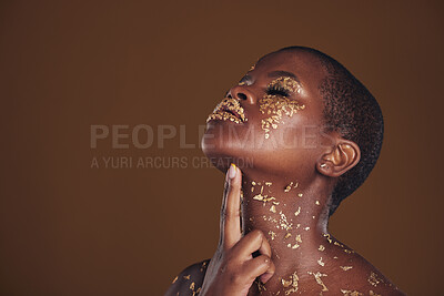 Buy stock photo Profile, beauty and black woman with gold makeup, mockup and brown background with art, glitter paint and cosmetics. Shine, glow and African model in studio space for aesthetic, luxury and skincare.